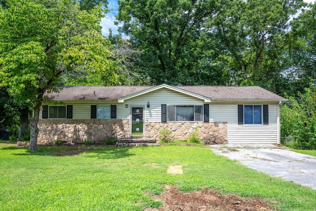 7635 Austin Dr, Chattanooga, TN 37416 - ranch-style house featuring stone siding, a front yard, and a shingled roof