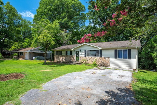 7635 Austin Dr, Chattanooga, TN 37416 - ranch-style house with a front lawn, driveway, and stone siding