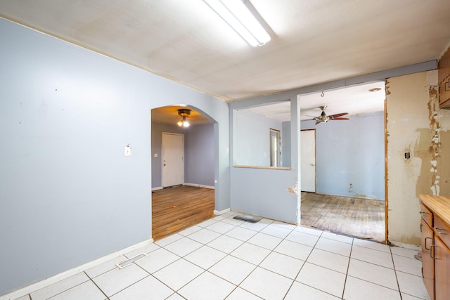 7635 Austin Dr, Chattanooga, TN 37416 - spare room with arched walkways, a ceiling fan, and light tile patterned flooring