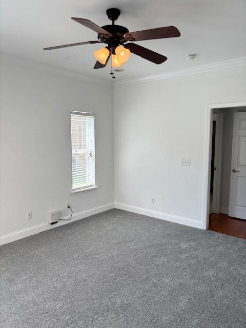 731 Callaway Ct, Chattanooga, TN 37421 - unfurnished room with ornamental molding, dark carpet, ceiling fan, and a smoke detector