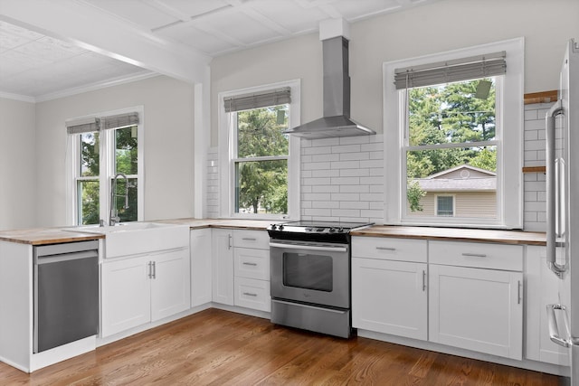 6863 Standifer Gap Rd, Chattanooga, TN 37421 - kitchen featuring stainless steel appliances, wall chimney range hood, butcher block counters, healthy amount of natural light, and ornamental molding