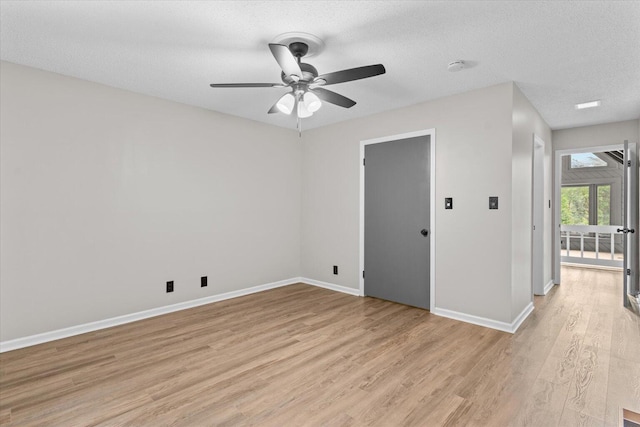 2219 Rocky Face Cir, Dalton, GA 30720 - empty room featuring light wood-style floors, ceiling fan, and a textured ceiling