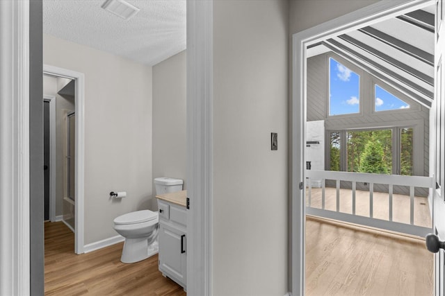 2219 Rocky Face Cir, Dalton, GA 30720 - bathroom with a shower with door, wood finished floors, vanity, and a textured ceiling