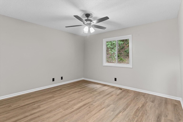 2219 Rocky Face Cir, Dalton, GA 30720 - empty room with light wood finished floors, a textured ceiling, and a ceiling fan