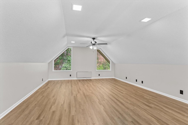 2219 Rocky Face Cir, Dalton, GA 30720 - additional living space with light wood-type flooring, a ceiling fan, lofted ceiling, and a textured ceiling