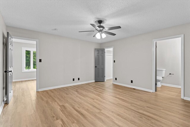 2219 Rocky Face Cir, Dalton, GA 30720 - unfurnished bedroom featuring light wood-style flooring, a textured ceiling, ceiling fan, and connected bathroom