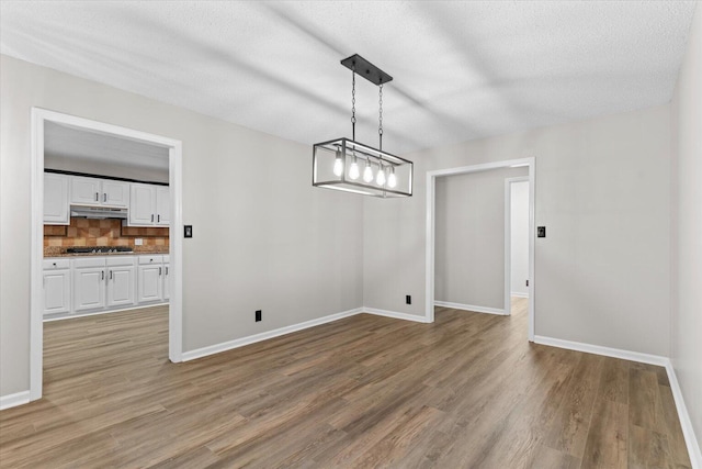 2219 Rocky Face Cir, Dalton, GA 30720 - unfurnished dining area with light wood-type flooring and a textured ceiling