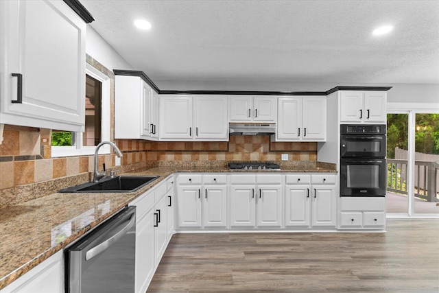2219 Rocky Face Cir, Dalton, GA 30720 - kitchen with stainless steel appliances, under cabinet range hood, recessed lighting, light wood finished floors, and light stone countertops