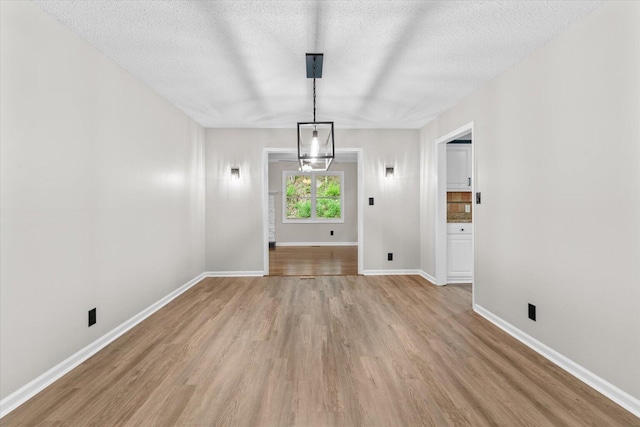 2219 Rocky Face Cir, Dalton, GA 30720 - unfurnished dining area featuring light wood finished floors and a textured ceiling