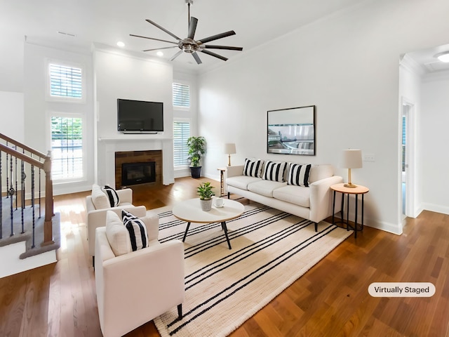 1783 Andover Pl, Chattanooga, TN 37421 - living room featuring stairway, crown molding, a ceiling fan, wood finished floors, and a glass covered fireplace