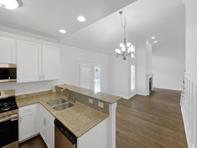 1783 Andover Pl, Chattanooga, TN 37421 - kitchen with appliances with stainless steel finishes, a peninsula, white cabinetry, decorative backsplash, and light stone countertops