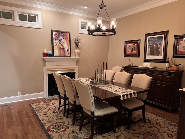 8712 Brow Lake Rd, Soddy Daisy, TN 37379 - dining area with dark wood-style floors, a chandelier, crown molding, and a fireplace