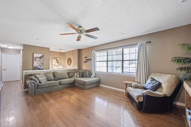 7700 Dune Ln, Hixson, TN 37343 - living area with wood-type flooring, a ceiling fan, and a textured ceiling