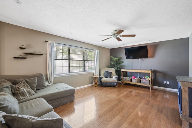 7700 Dune Ln, Hixson, TN 37343 - living area with wood finished floors, a ceiling fan, and a textured ceiling