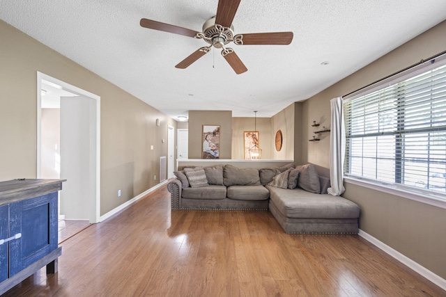 7700 Dune Ln, Hixson, TN 37343 - living area featuring wood finished floors, a ceiling fan, and a textured ceiling