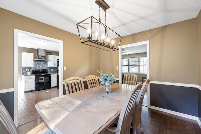 7700 Dune Ln, Hixson, TN 37343 - dining space with a chandelier, a ceiling fan, and wood finished floors
