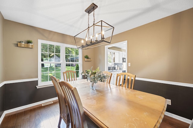 7700 Dune Ln, Hixson, TN 37343 - dining area with a chandelier and dark wood-style floors
