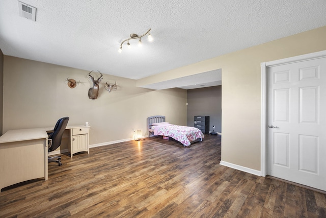 7700 Dune Ln, Hixson, TN 37343 - bedroom with dark wood finished floors, a textured ceiling, and an office area