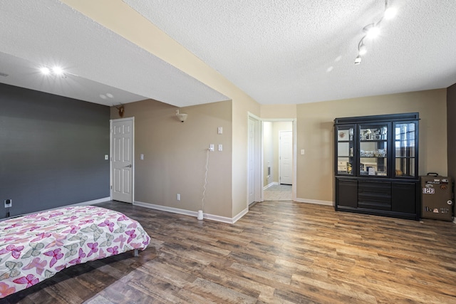 7700 Dune Ln, Hixson, TN 37343 - bedroom with a textured ceiling and wood finished floors