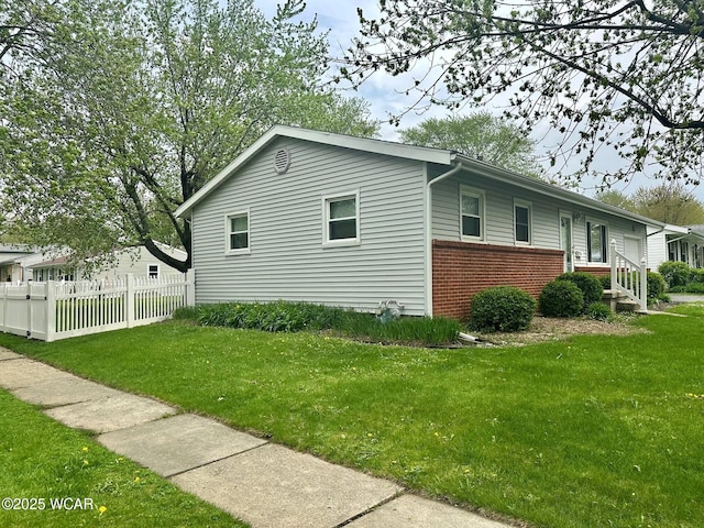 510 Rosewood Ave, Findlay, OH 45840 - view of property exterior featuring a lawn, brick siding, and fence