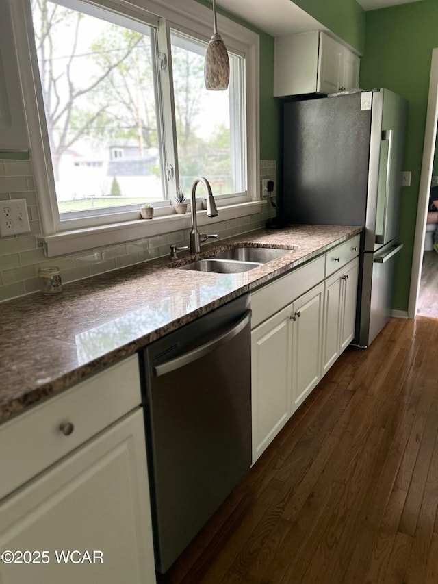 510 Rosewood Ave, Findlay, OH 45840 - kitchen featuring white cabinets, tasteful backsplash, a sink, dark wood finished floors, and dishwasher