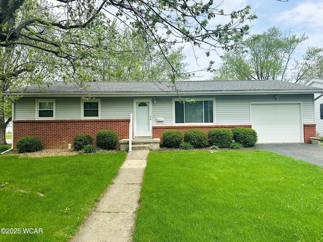 510 Rosewood Ave, Findlay, OH 45840 - ranch-style home featuring a front yard, roof with shingles, brick siding, an attached garage, and driveway
