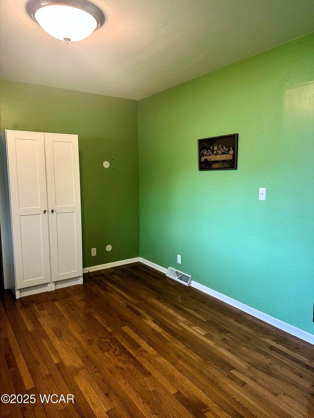510 Rosewood Ave, Findlay, OH 45840 - unfurnished bedroom featuring baseboards, visible vents, and dark wood-type flooring