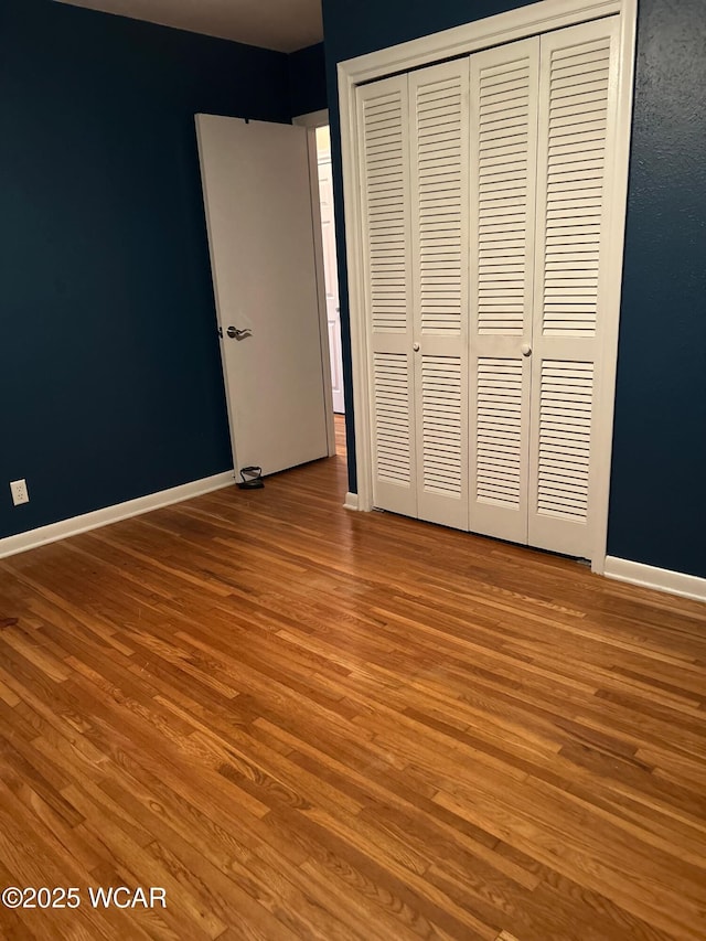 510 Rosewood Ave, Findlay, OH 45840 - unfurnished bedroom featuring baseboards, wood finished floors, and a closet