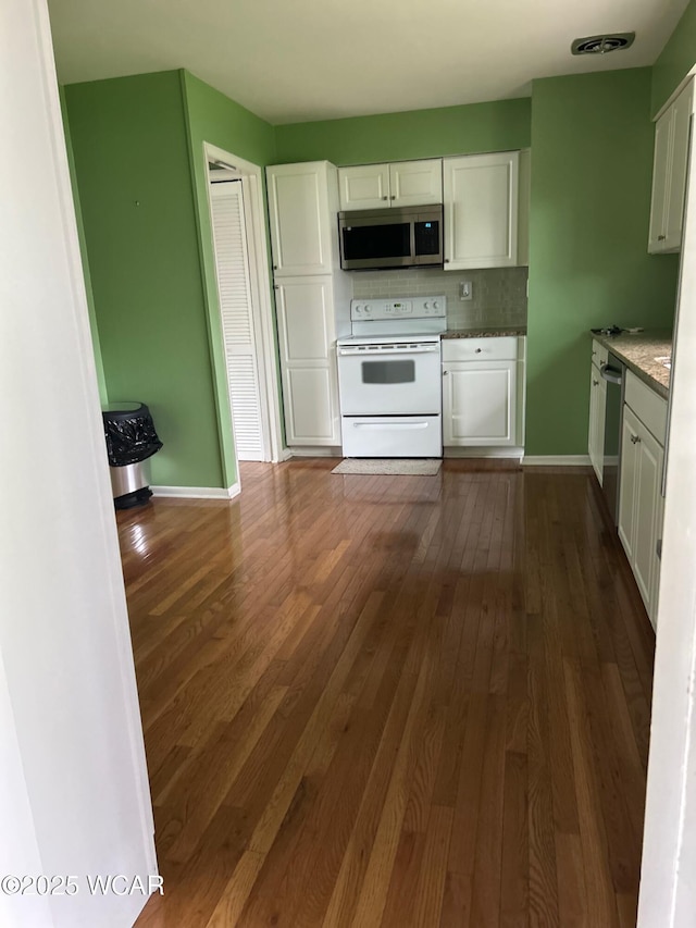 510 Rosewood Ave, Findlay, OH 45840 - kitchen featuring white cabinets, appliances with stainless steel finishes, baseboards, dark wood-type flooring, and backsplash