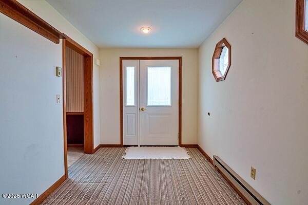 entryway featuring light carpet and baseboard heating