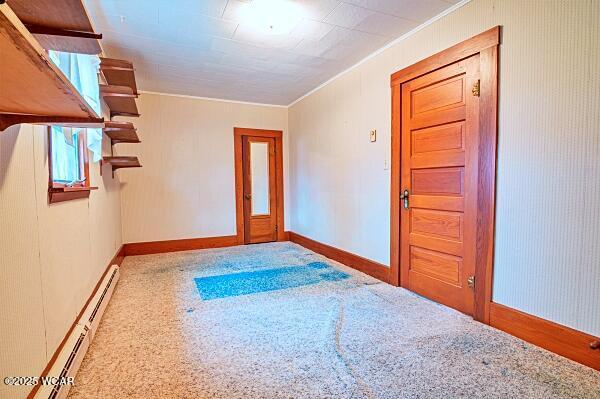 interior space featuring baseboard heating and ornamental molding