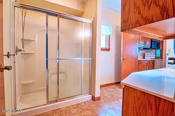 bathroom with a shower with door