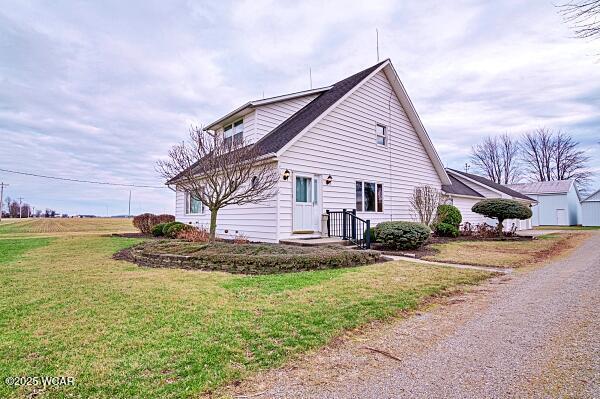 view of side of home featuring a lawn