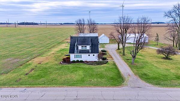 birds eye view of property with a rural view