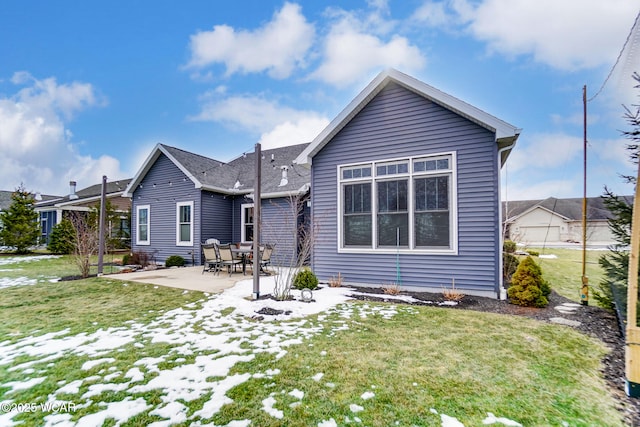 back of house featuring a patio and a lawn