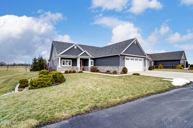 craftsman-style home featuring a garage and a front yard