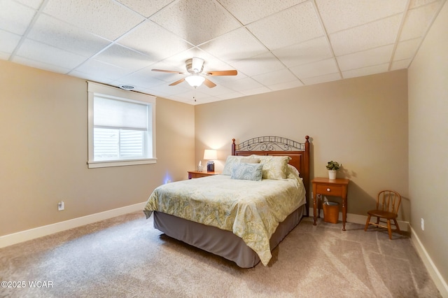 carpeted bedroom featuring a drop ceiling and ceiling fan