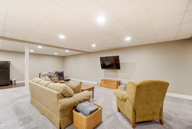 living room with light colored carpet and a drop ceiling