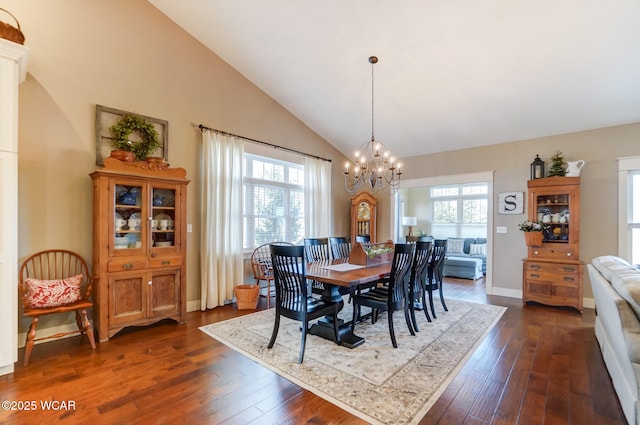 dining room with dark wood-type flooring, a chandelier, and high vaulted ceiling