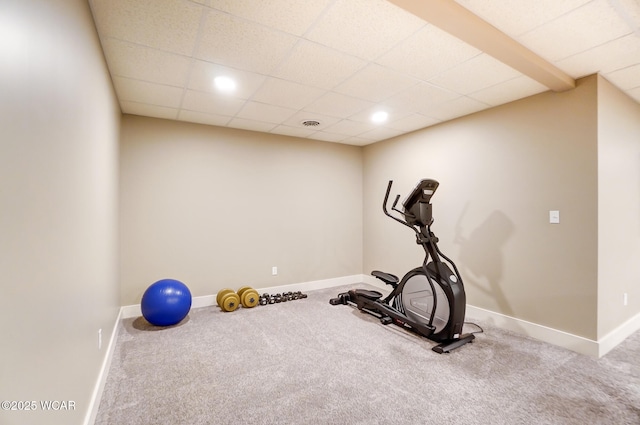 workout area with carpet floors and a drop ceiling