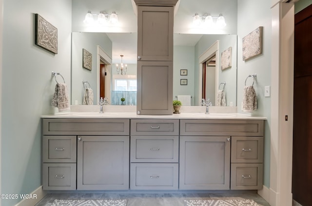 bathroom with vanity and an inviting chandelier