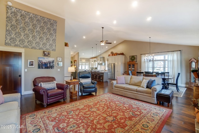 living room with dark wood-type flooring, vaulted ceiling, a healthy amount of sunlight, and ceiling fan with notable chandelier