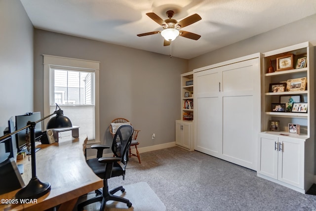 carpeted home office with ceiling fan