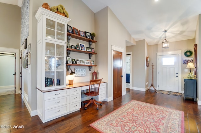 foyer entrance with built in desk and dark hardwood / wood-style flooring