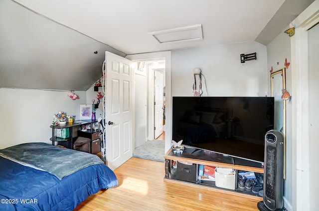 bedroom featuring lofted ceiling and hardwood / wood-style floors