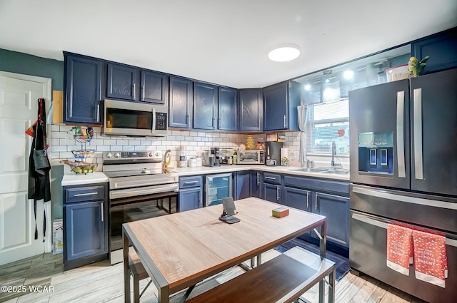 kitchen with stainless steel appliances and blue cabinetry