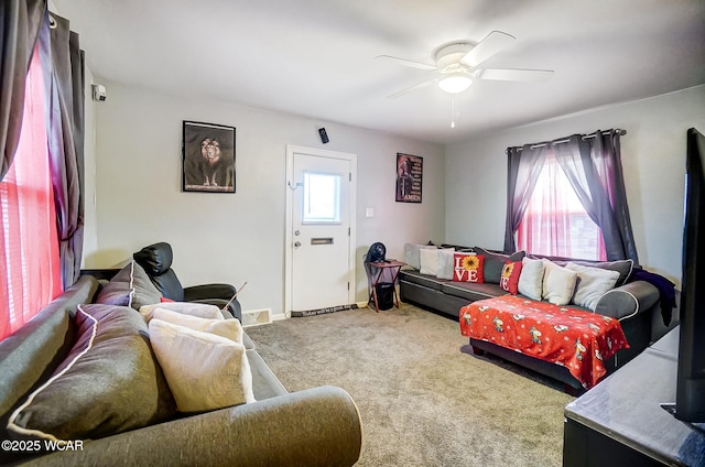 carpeted living room featuring ceiling fan