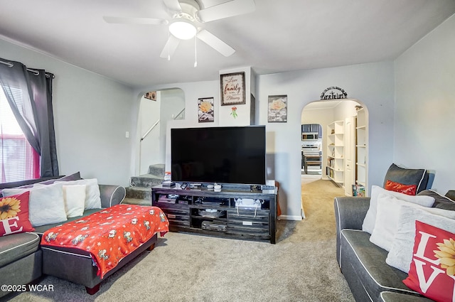 carpeted living room featuring ceiling fan