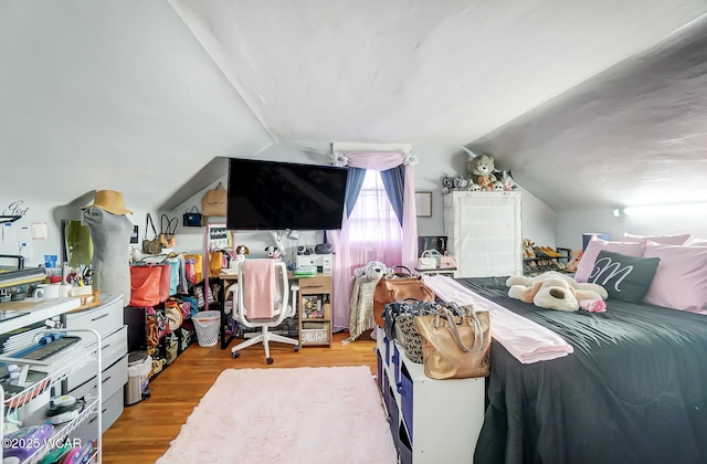 bedroom featuring vaulted ceiling and light wood-type flooring