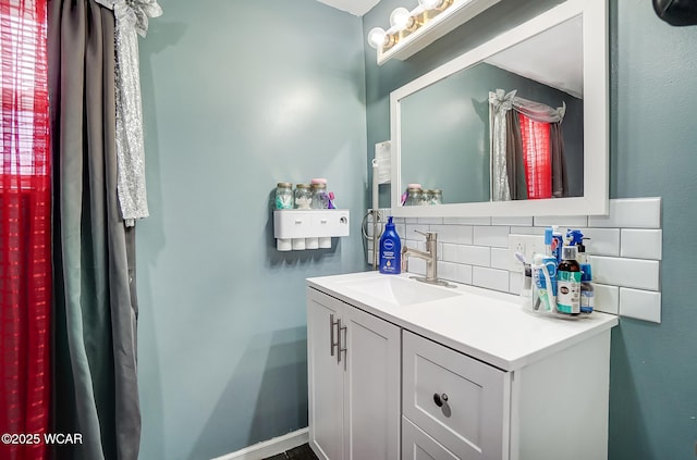 bathroom with tasteful backsplash and vanity